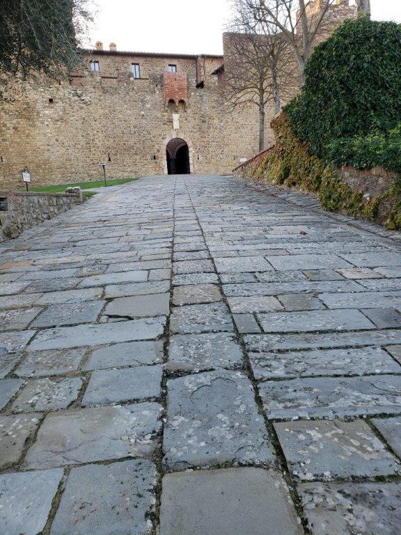 A stone walkway leading up to a stone building