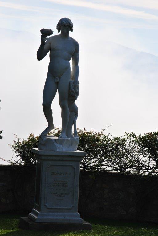 A statue of a man standing on a pedestal with a plaque on it
