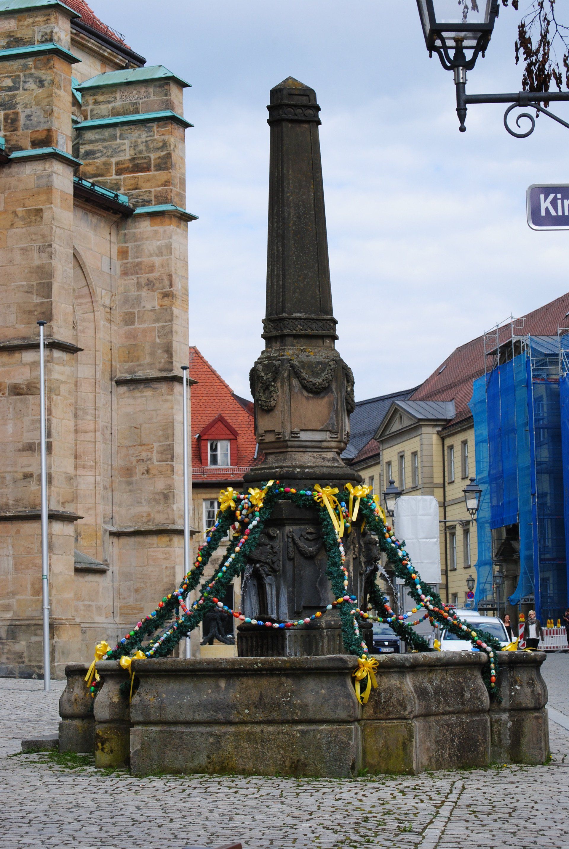 A stone obelisk with a sign that says kirch on it