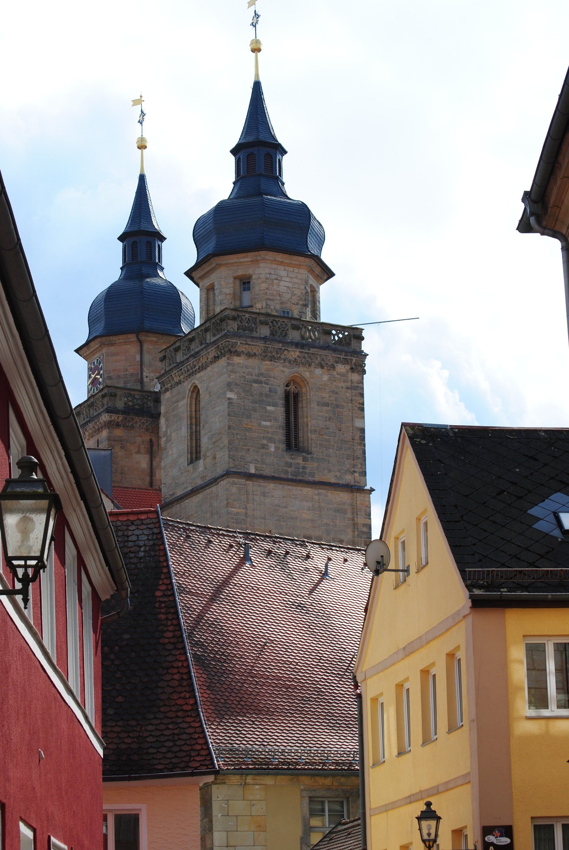 A row of buildings with a church in the background