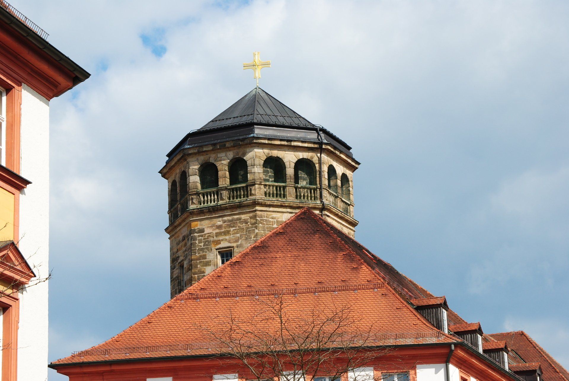 A tower with a cross on top of it