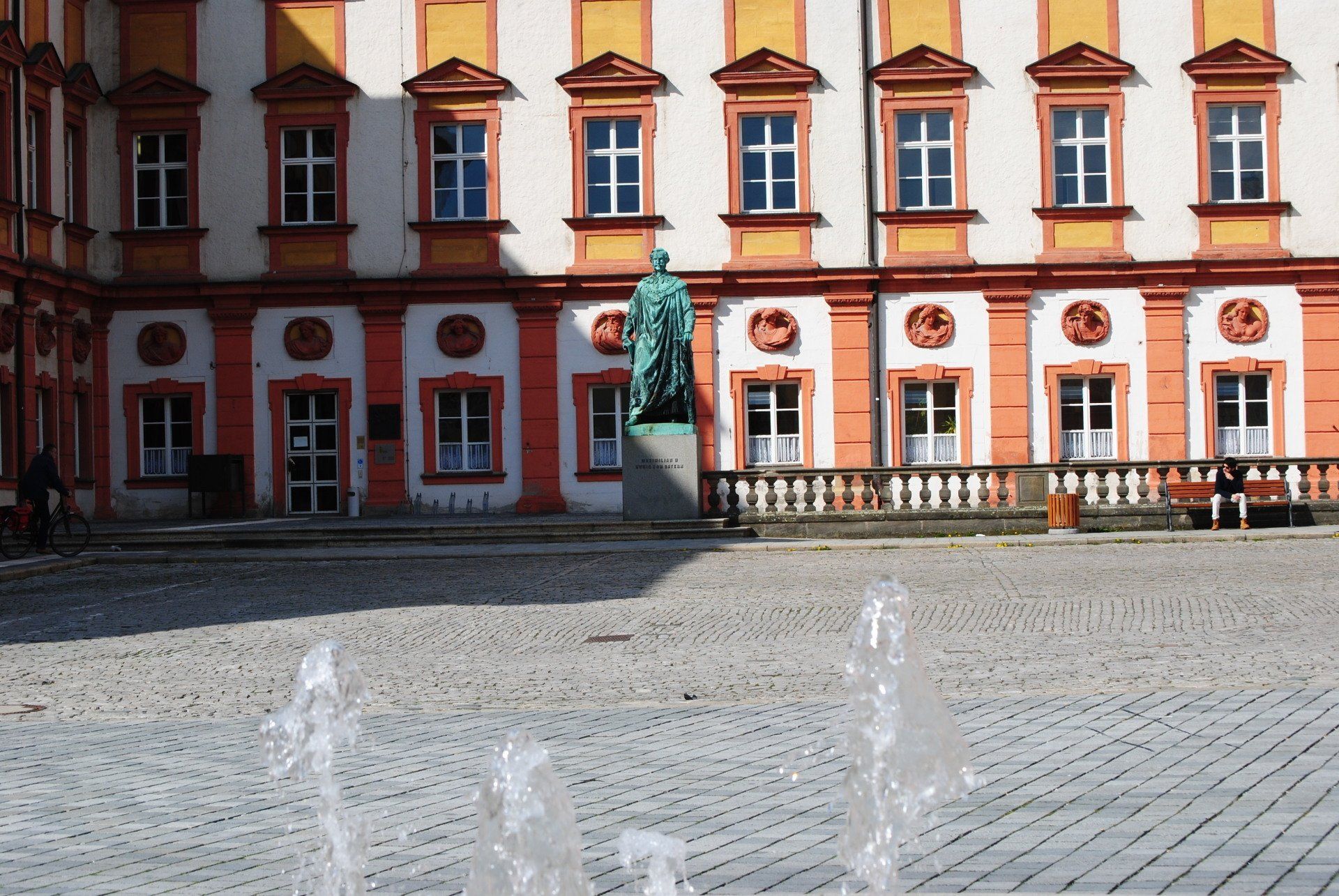 A large building with a fountain in front of it