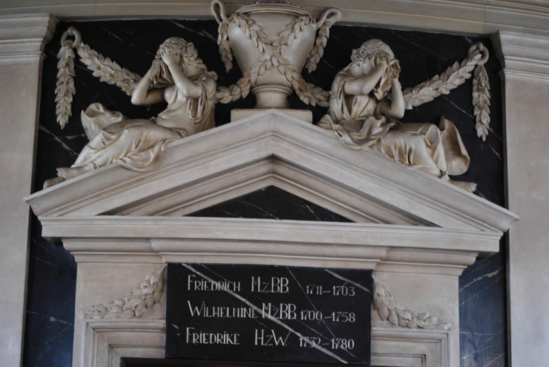 A statue of two angels on top of a building