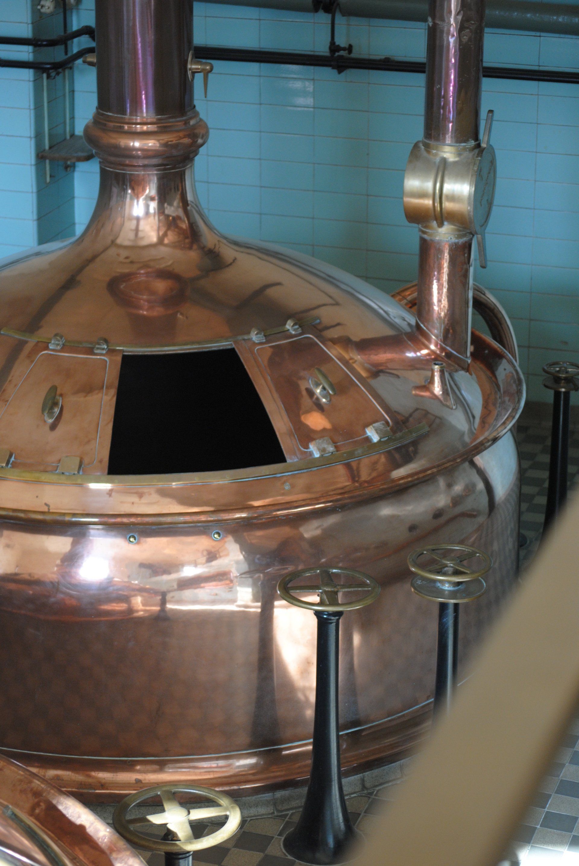 A large copper tank with a hole in the middle is in a room.