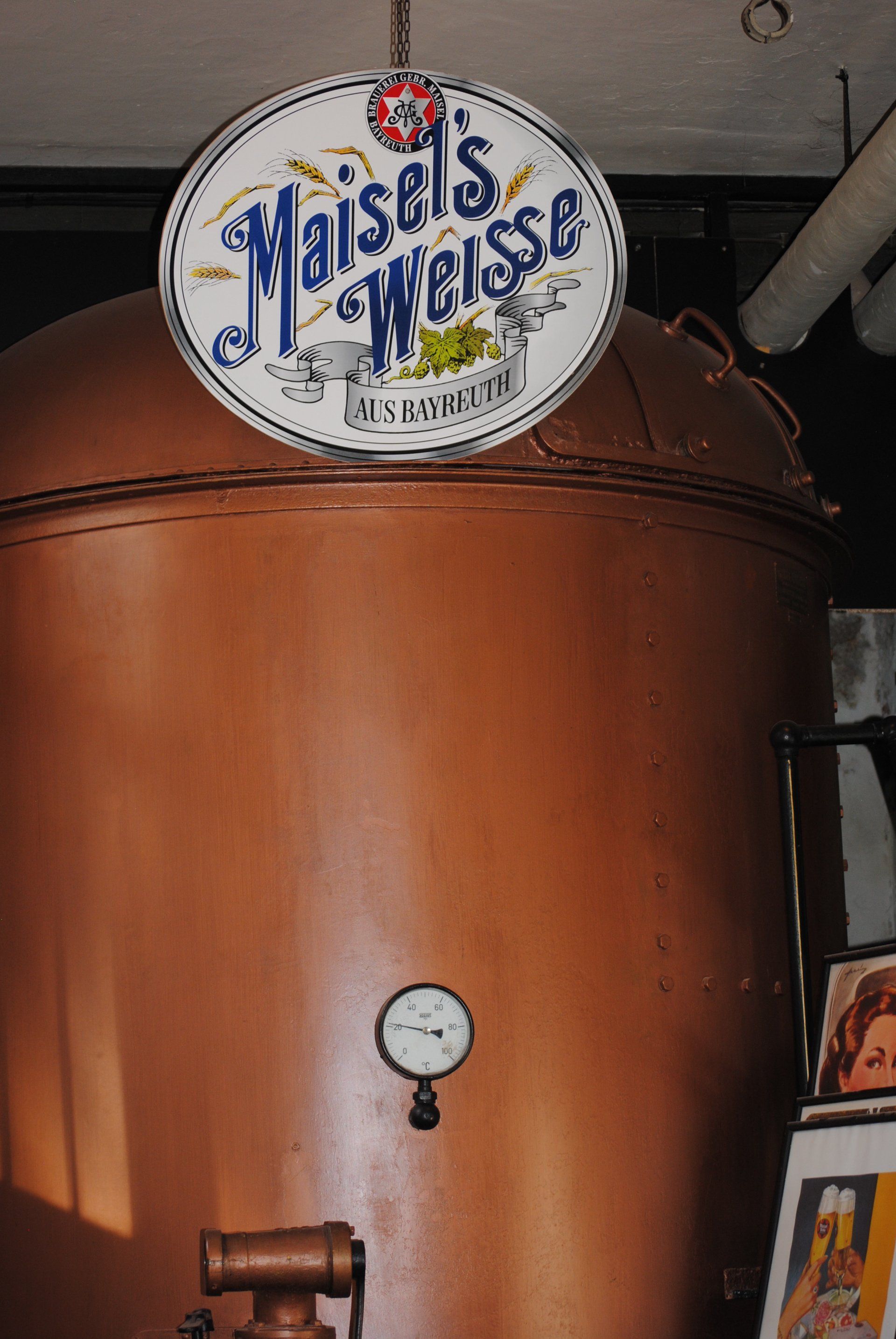 A copper tank with a sign that says maisels weisse on it
