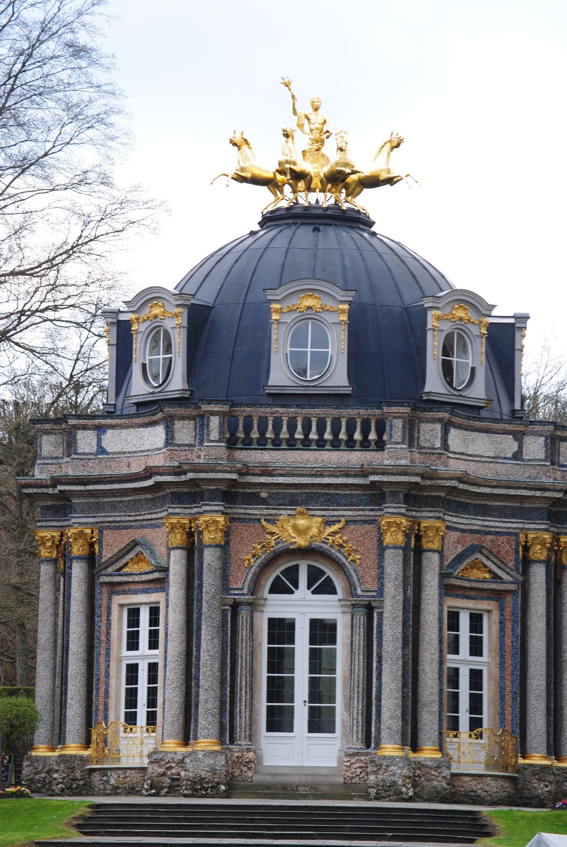 A building with a dome and statues on top of it