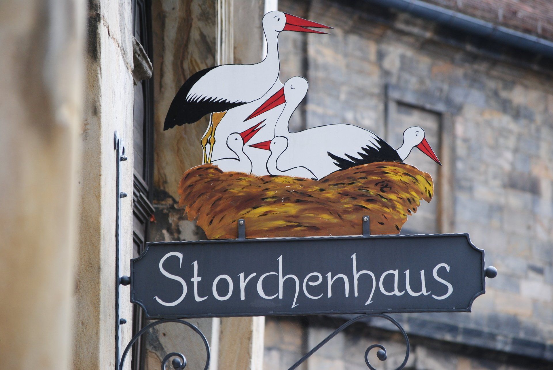 A storchenhaus sign hangs on the side of a building