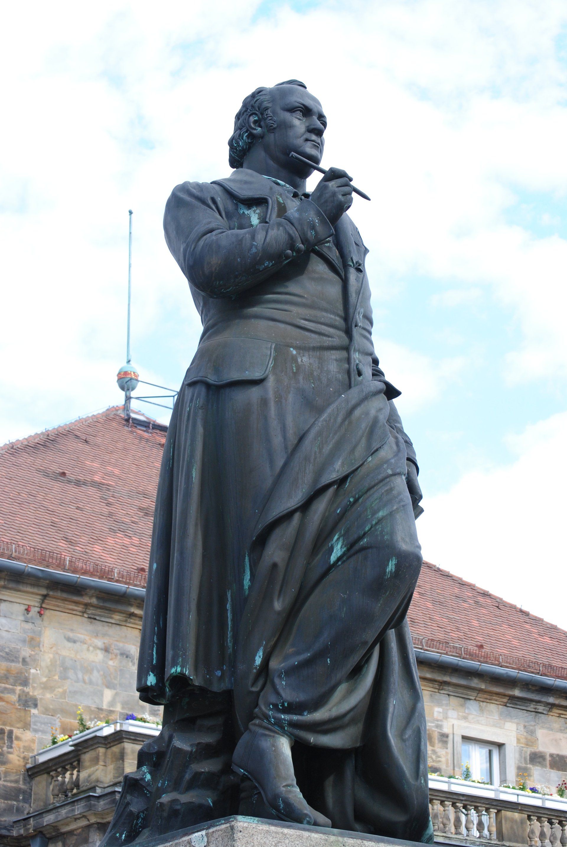 A statue of a man standing in front of a building