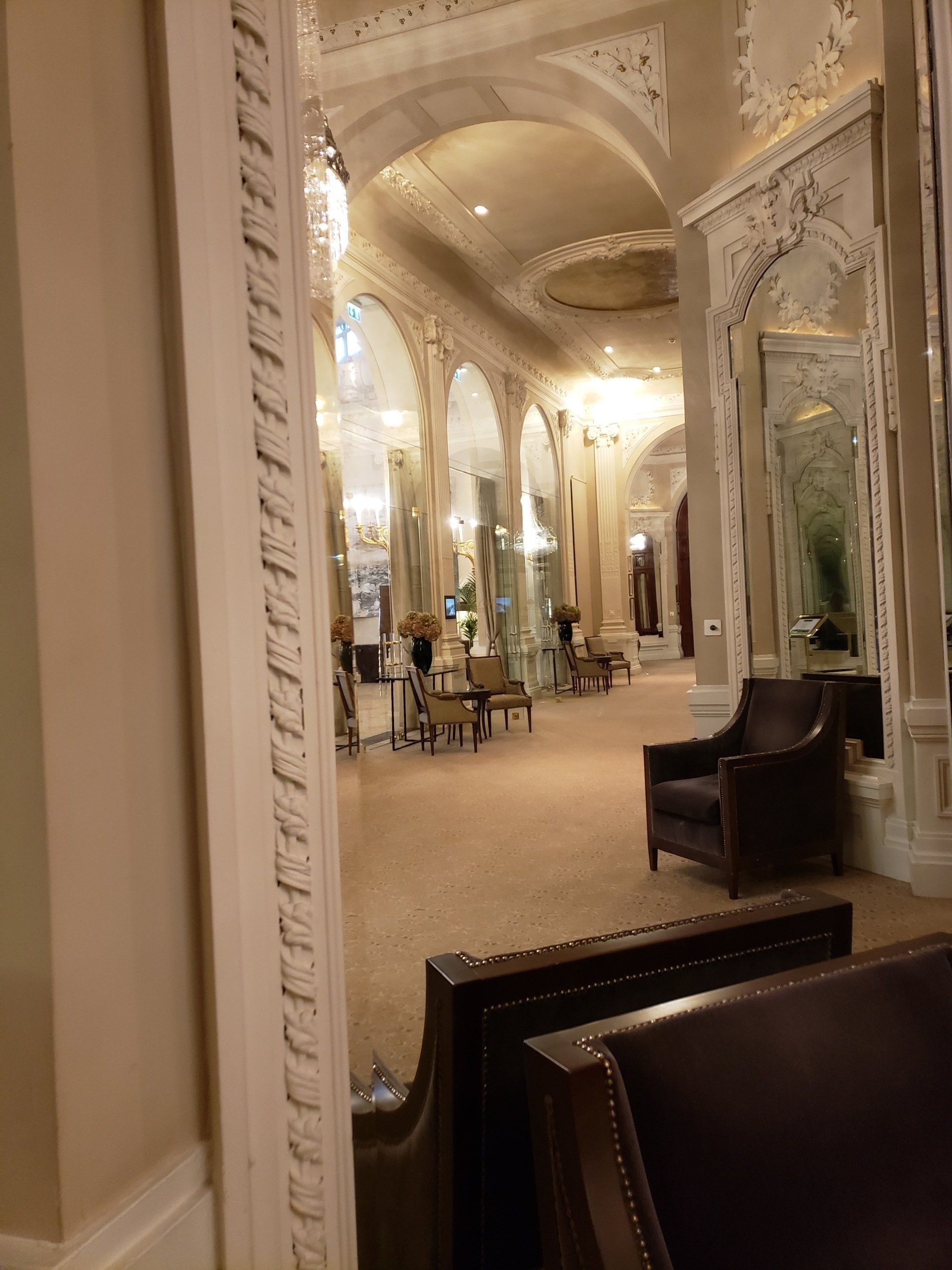 A large room with a lot of furniture and a large mirror.