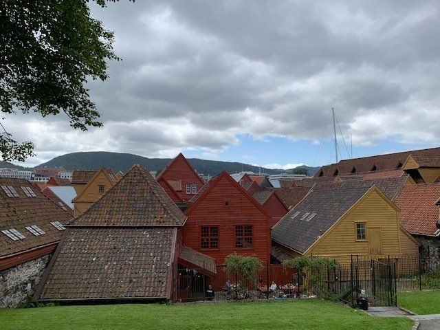 A row of houses with a cloudy sky in the background