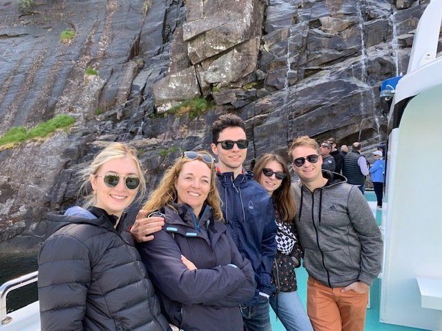 A group of people are posing for a picture on a boat.