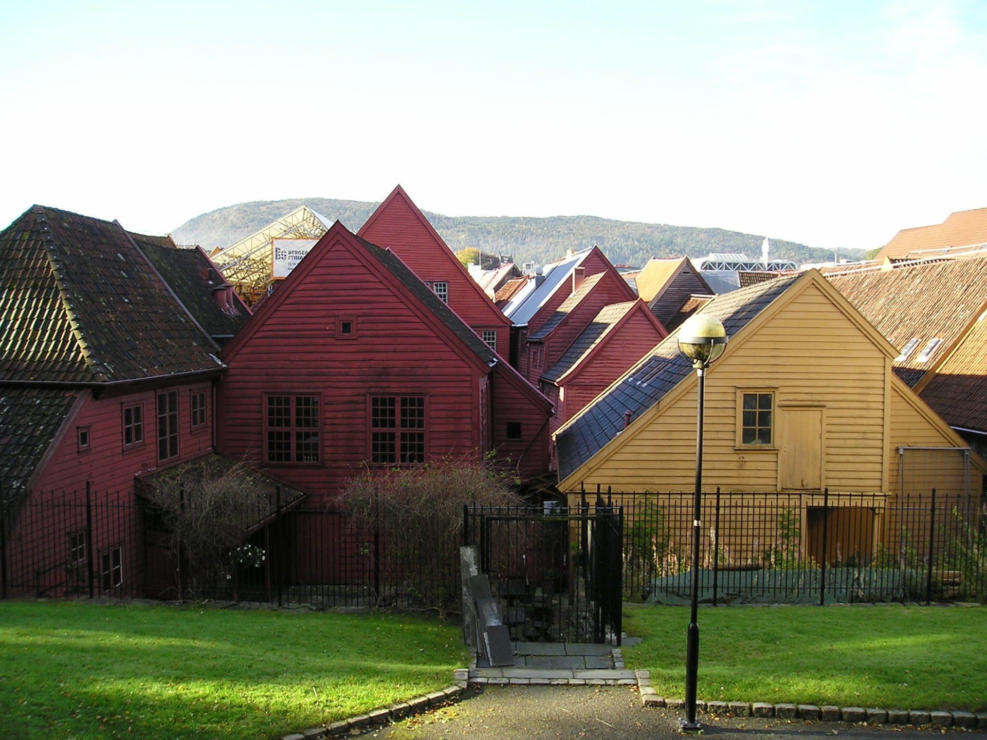 A row of red and yellow houses with mountains in the background