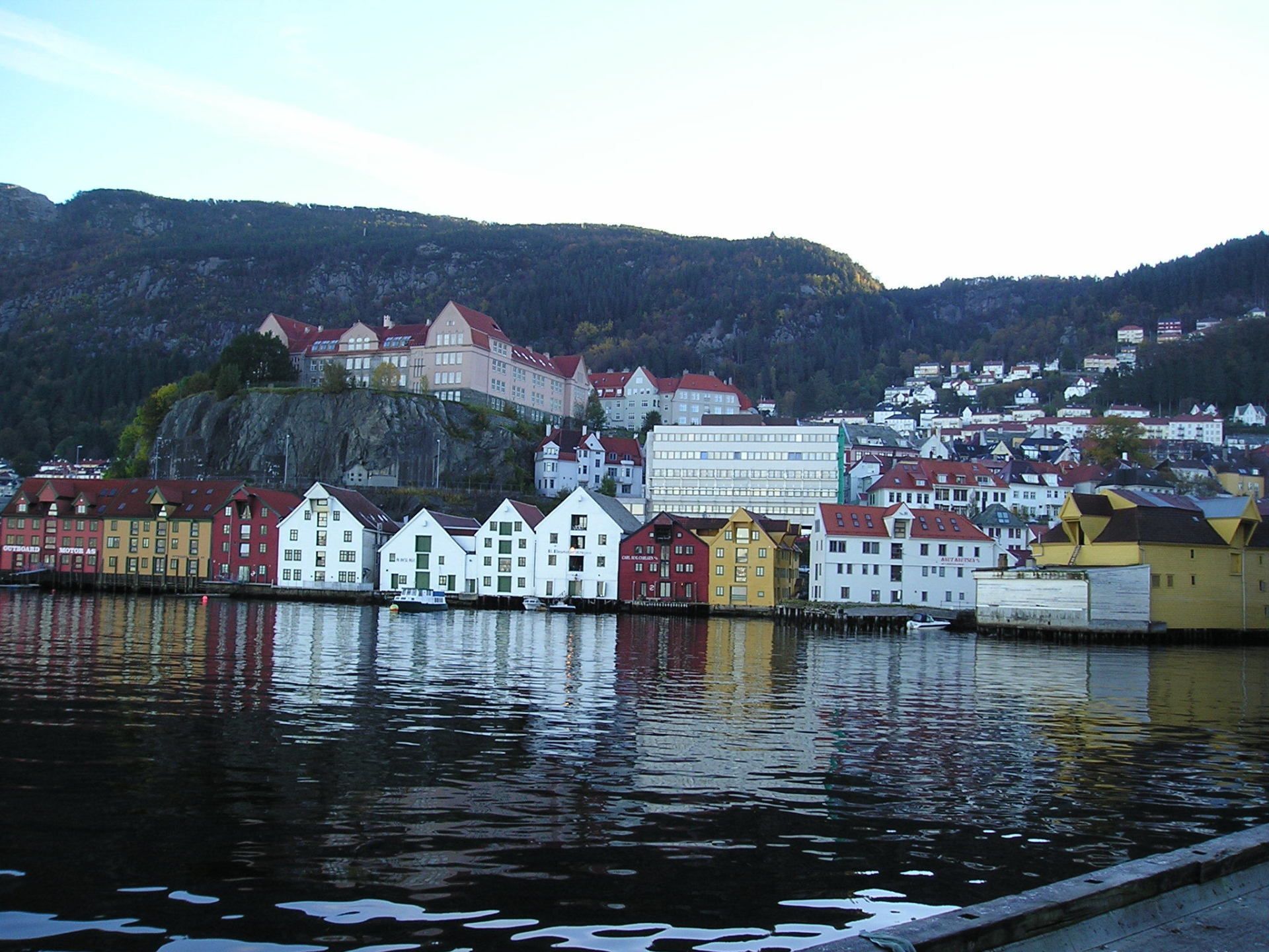 A city along a body of water with mountains in the background