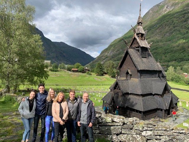 A group of people are posing for a picture in front of a church.