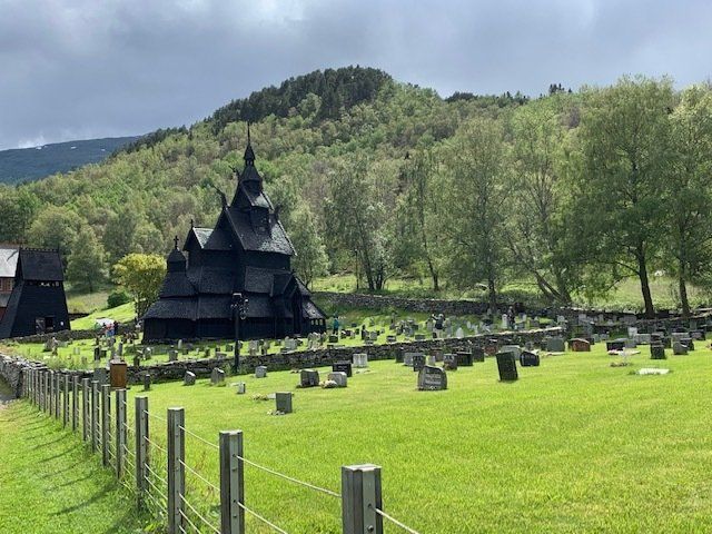 There is a cemetery in the foreground and a church in the background.