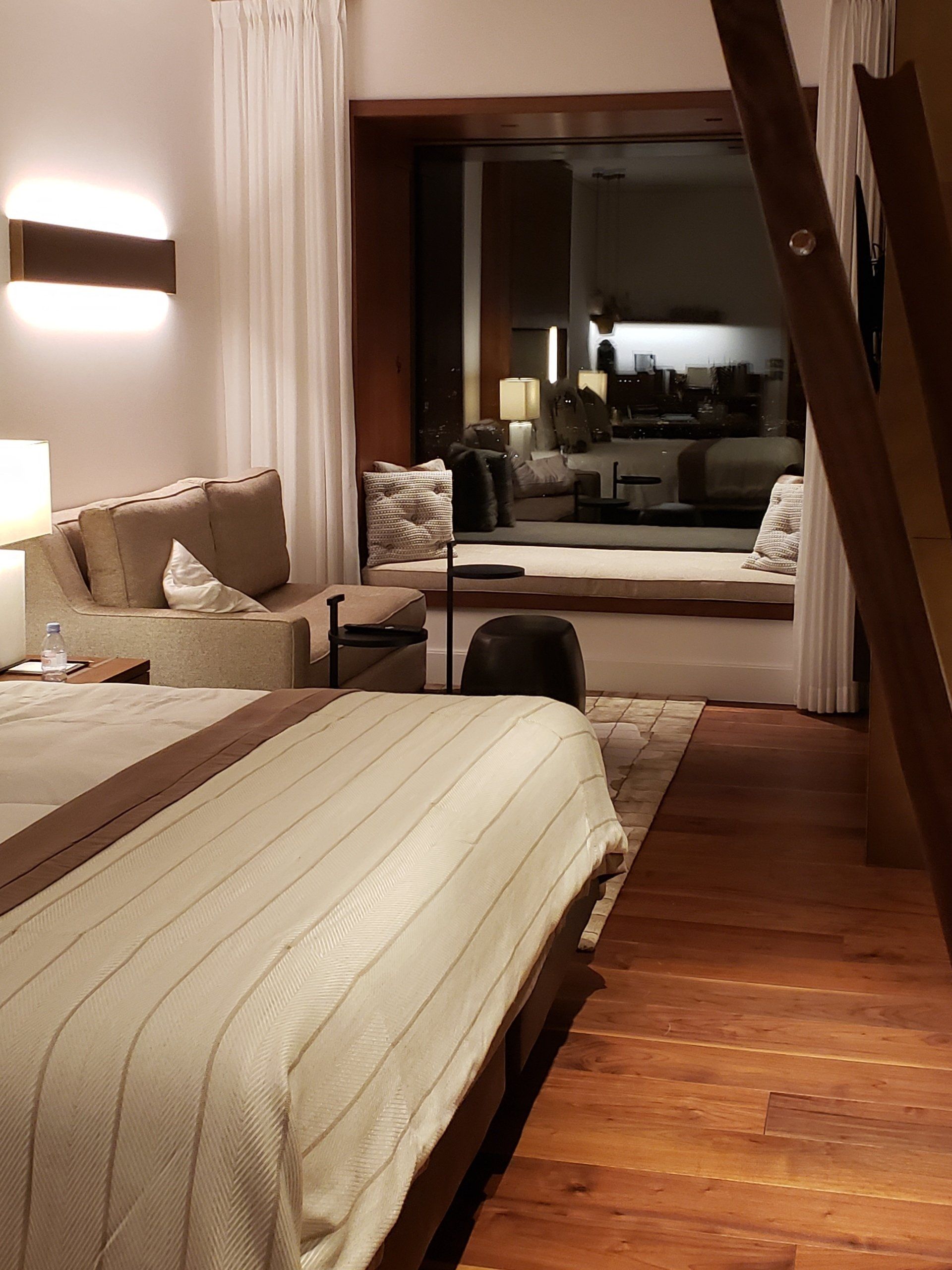 A hotel room with a large bed and a couch