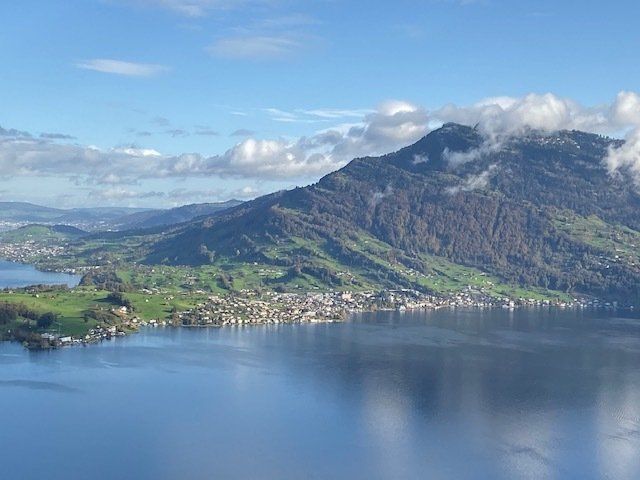 An aerial view of a lake with mountains in the background.