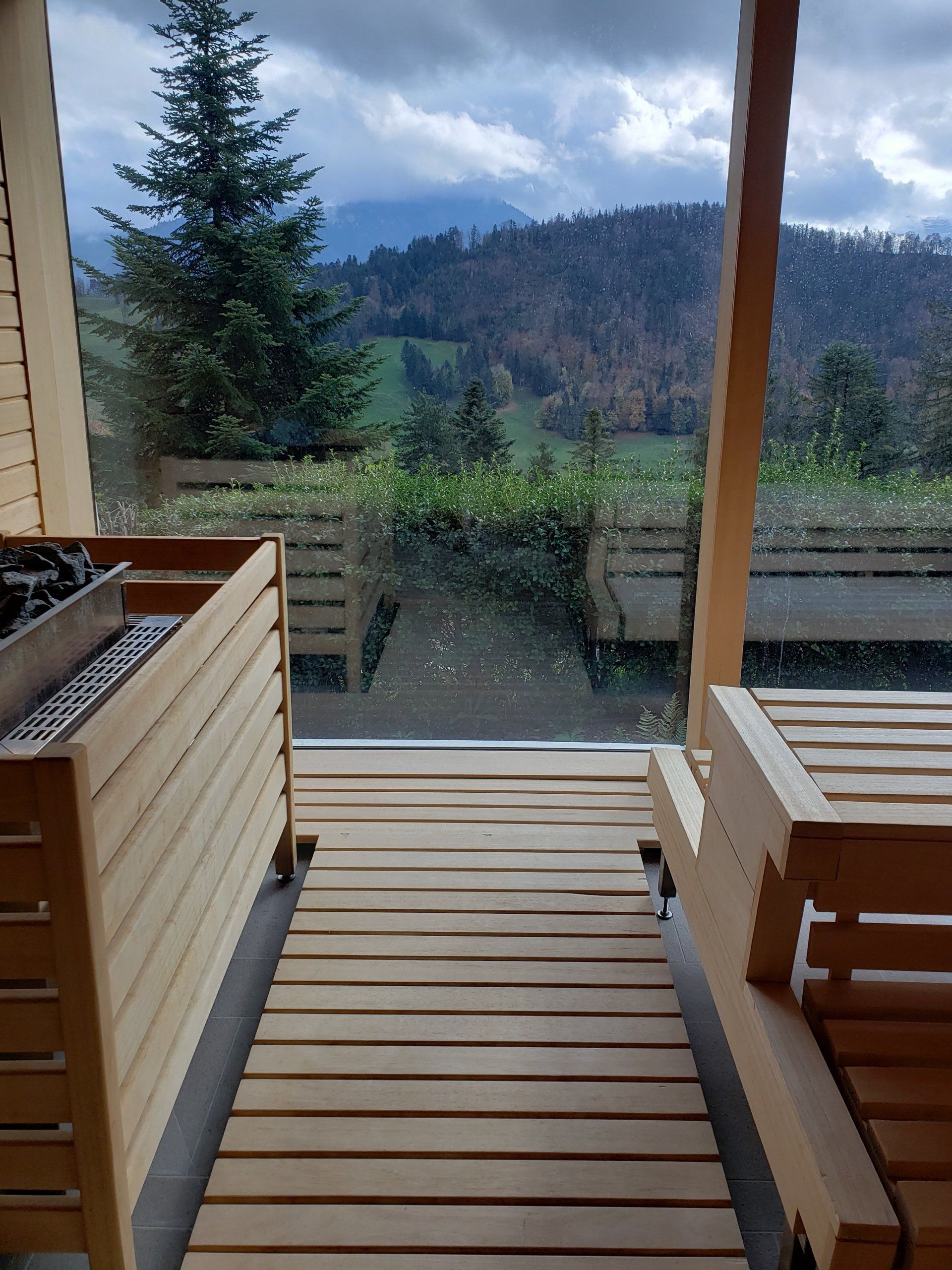 A wooden deck with a view of mountains and trees