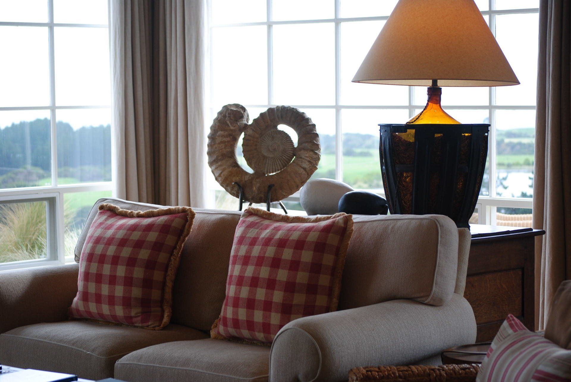 A living room with a couch and a lamp