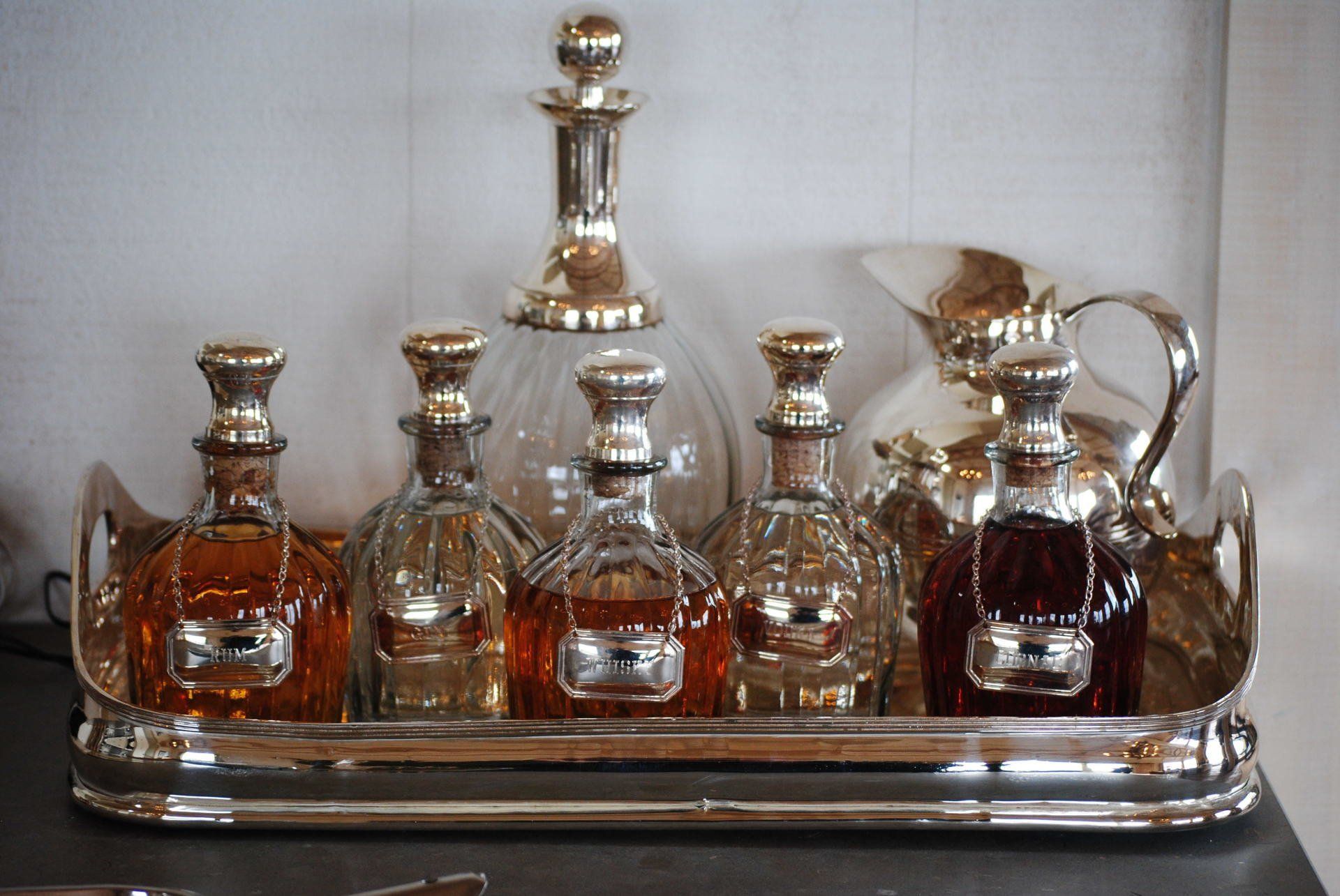 A silver tray with bottles of liquor on it