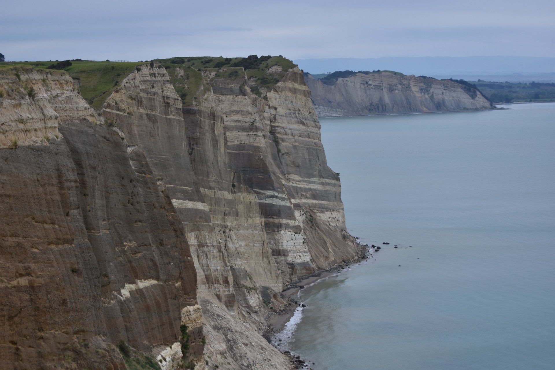 A view of a cliff overlooking a body of water