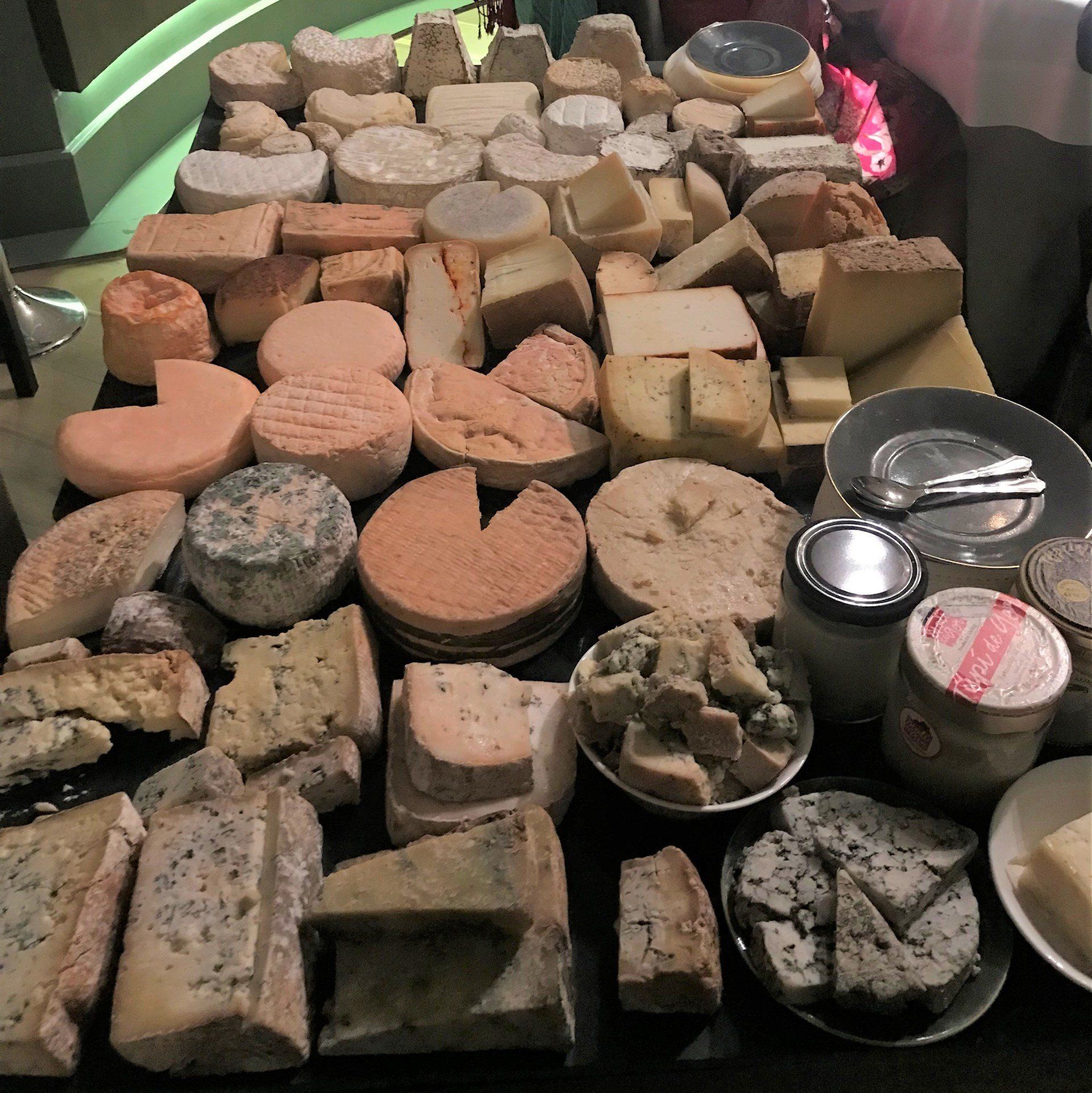 A table filled with lots of different types of cheese
