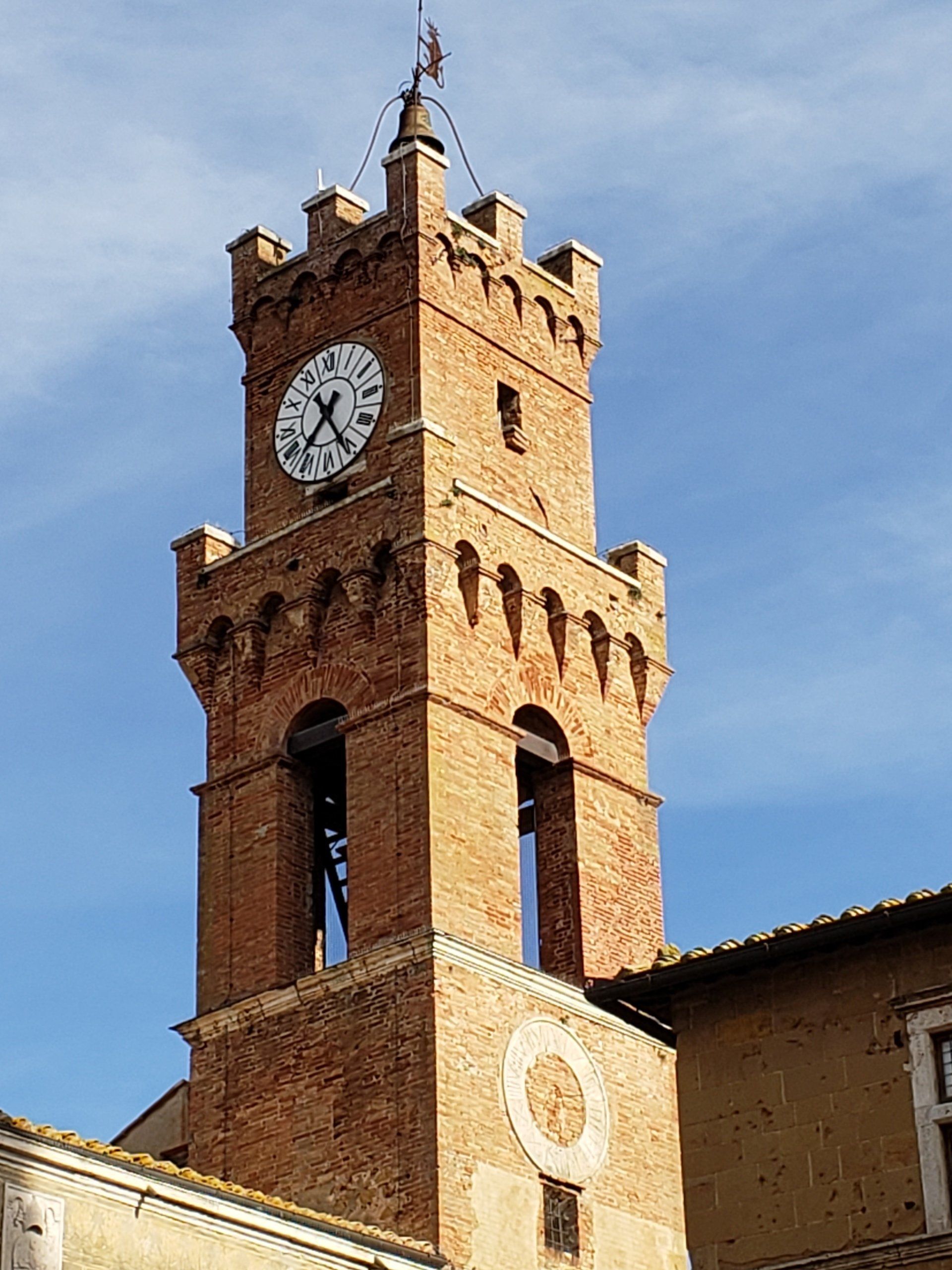A brick tower with a clock on top of it