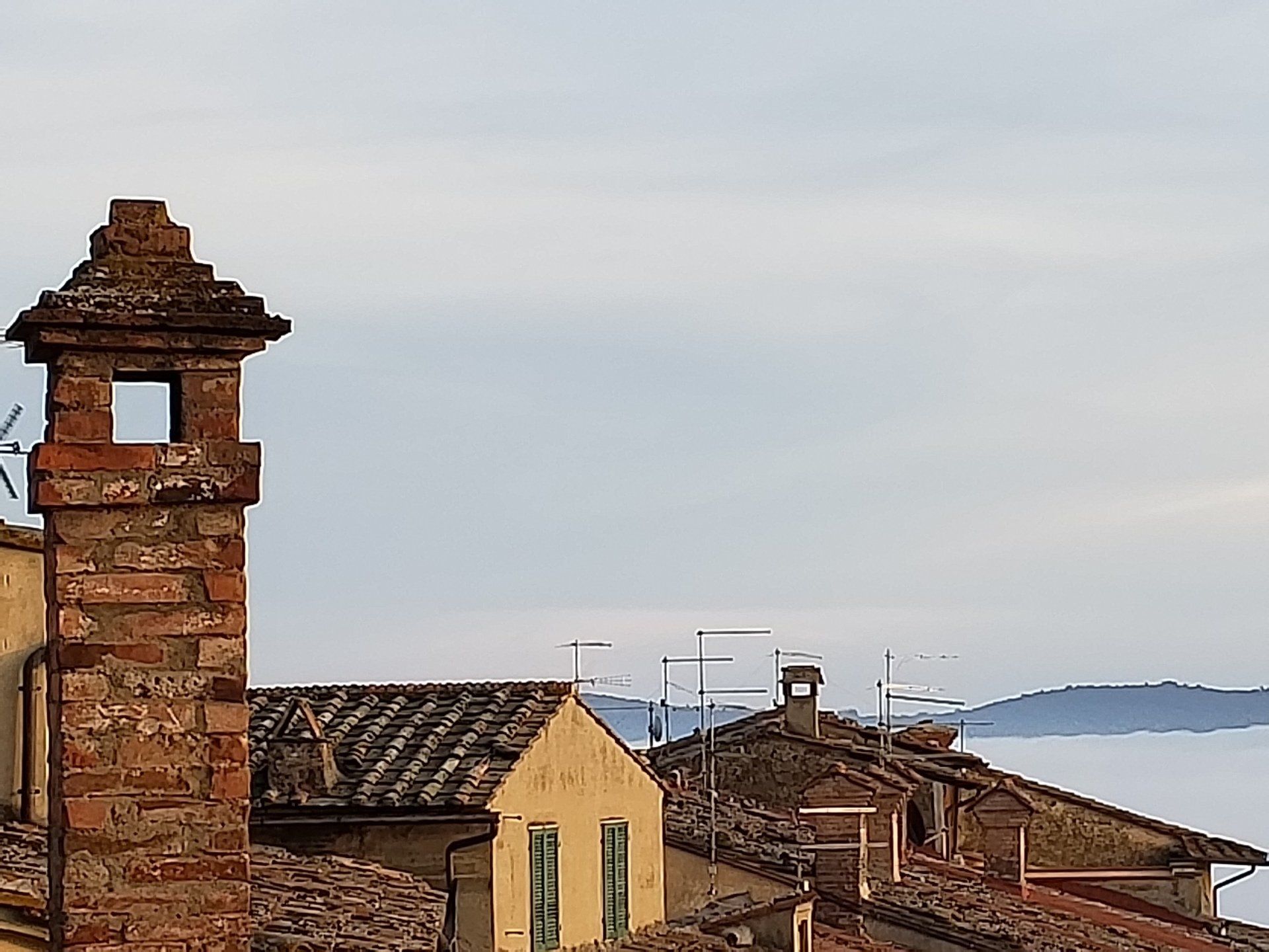 A brick chimney on top of a roof of a building