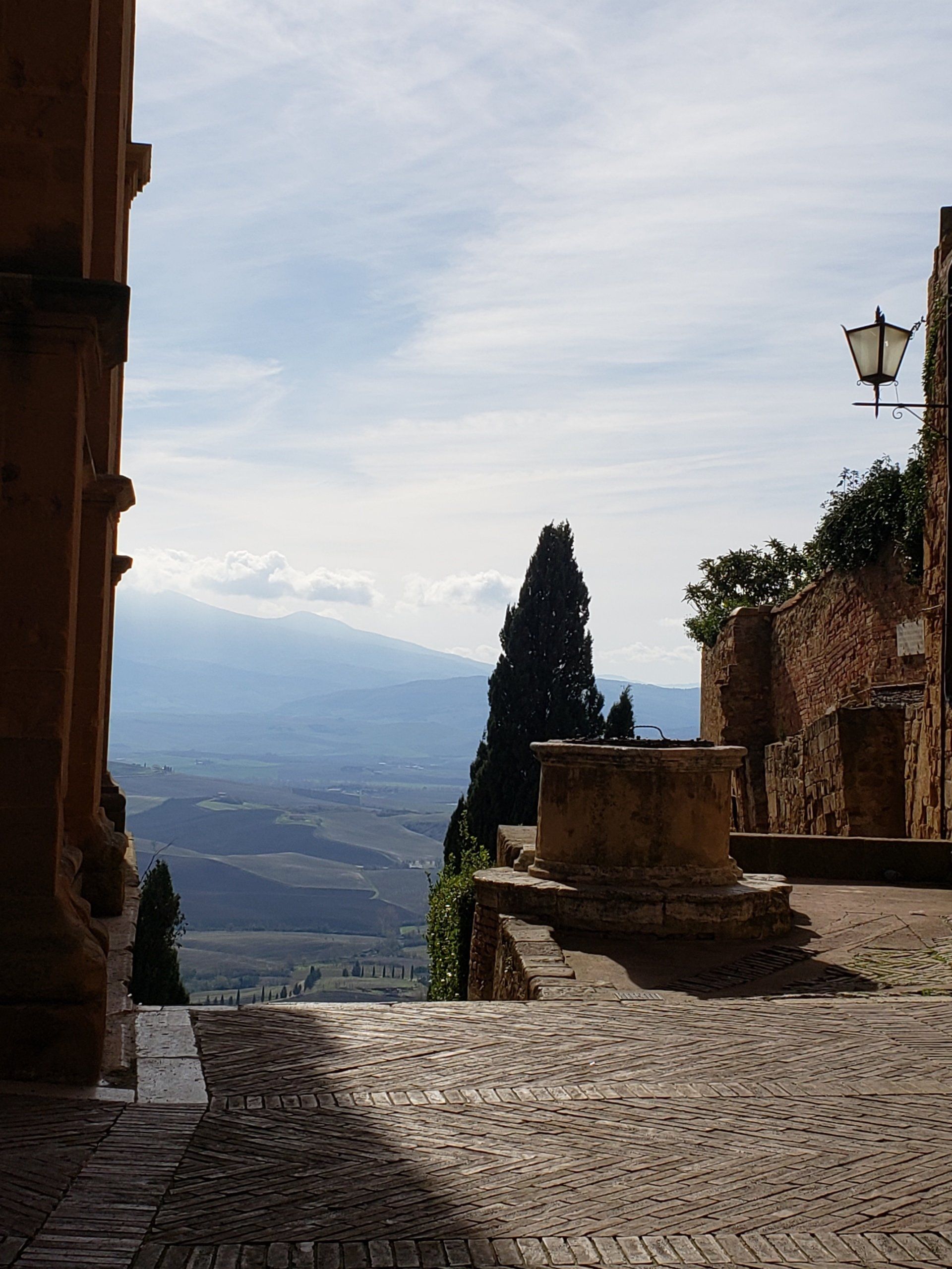 A cobblestone street with mountains in the background