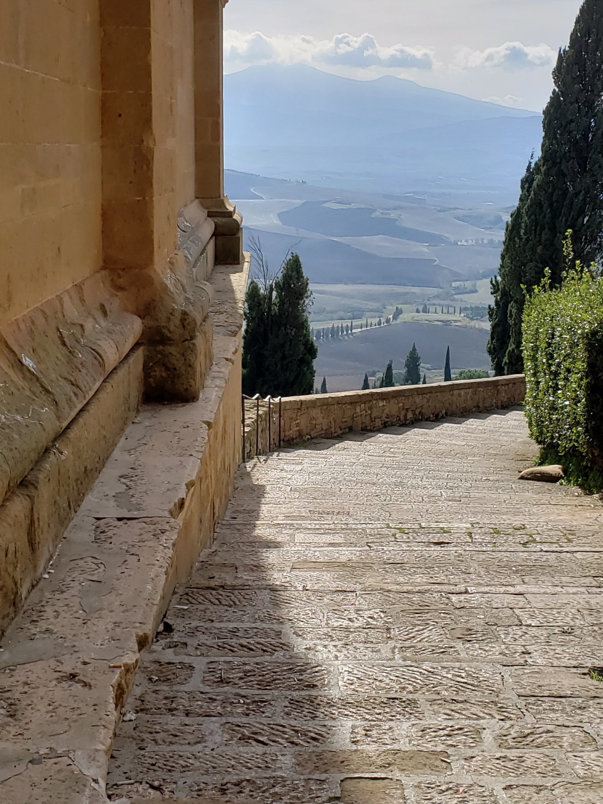 A stone walkway with a view of the mountains