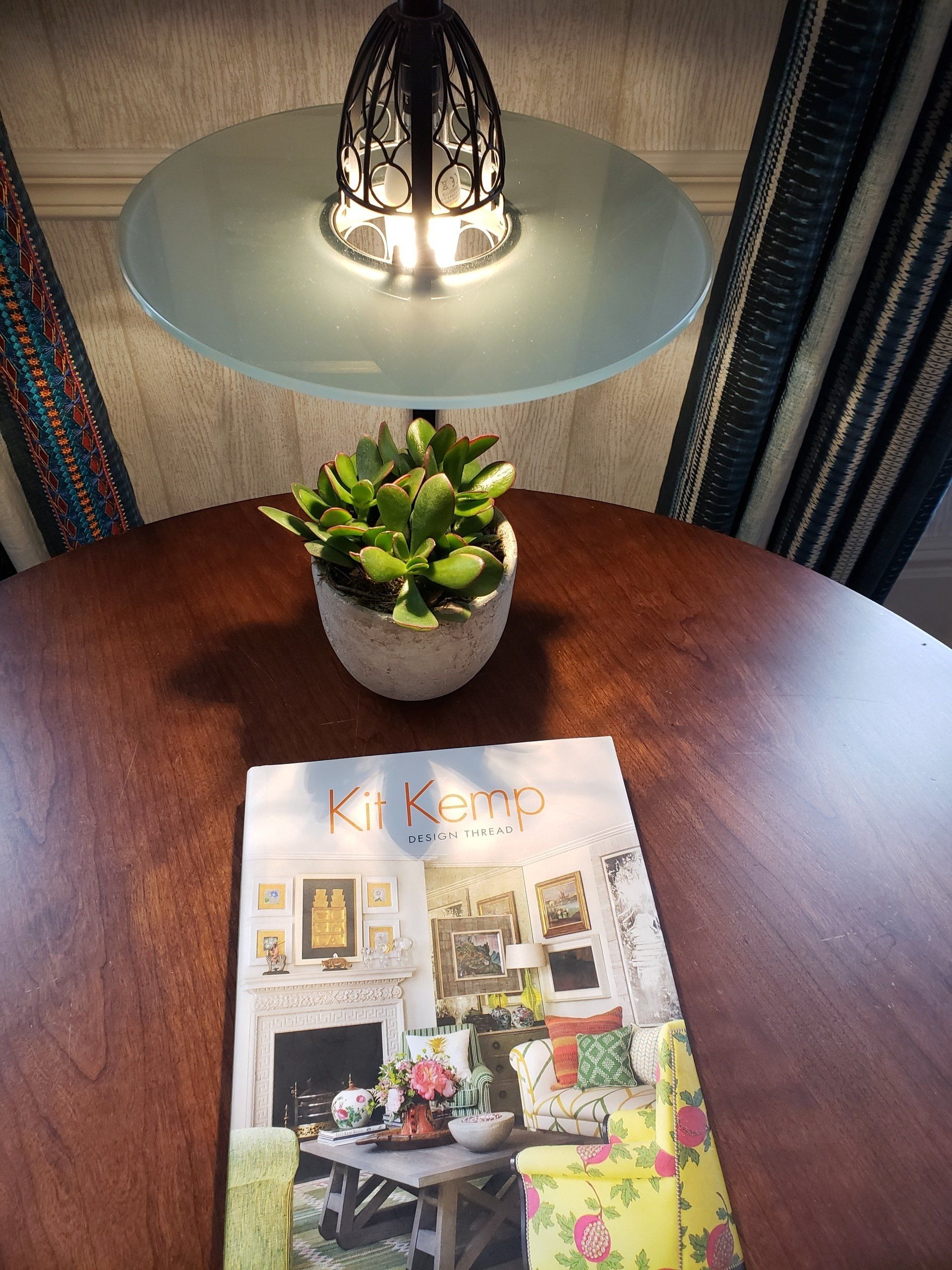 A table with a lamp and a magazine on it