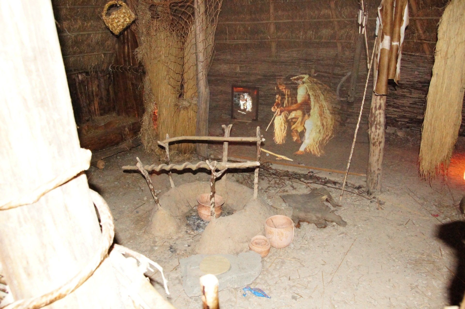 A room with a painting on the wall and a fireplace.