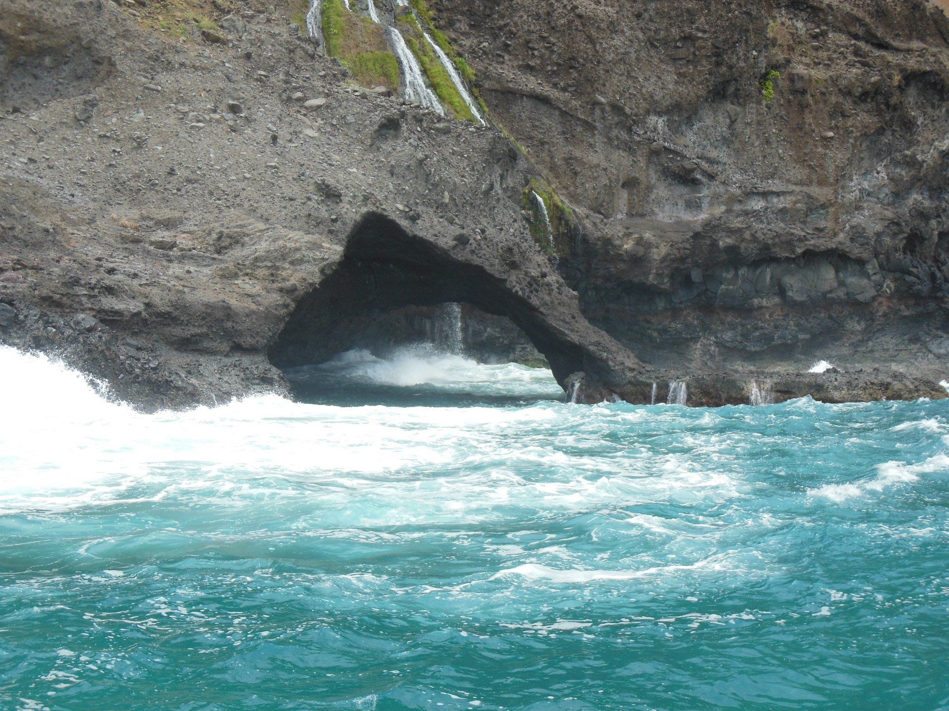 A large cave in the middle of a body of water