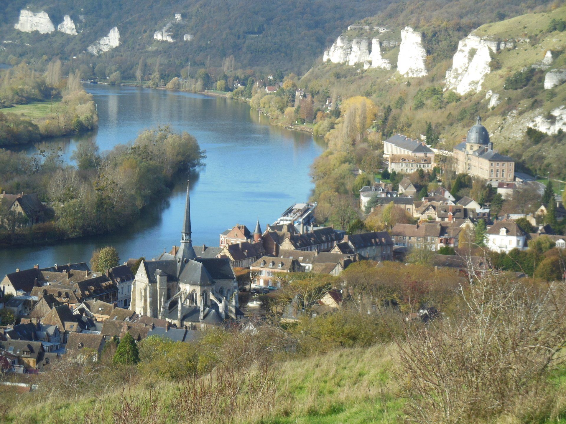 A small town sits on the shore of a river