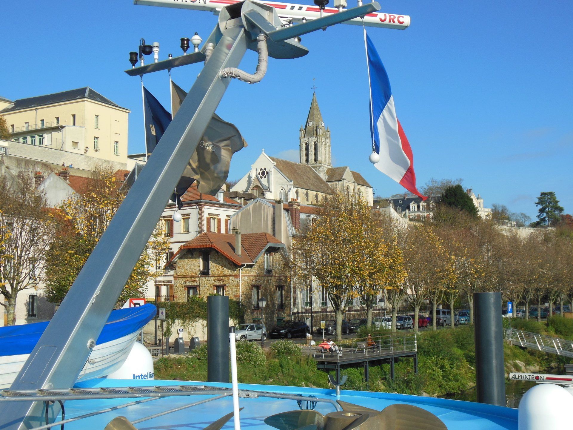 A french flag is flying in front of a city