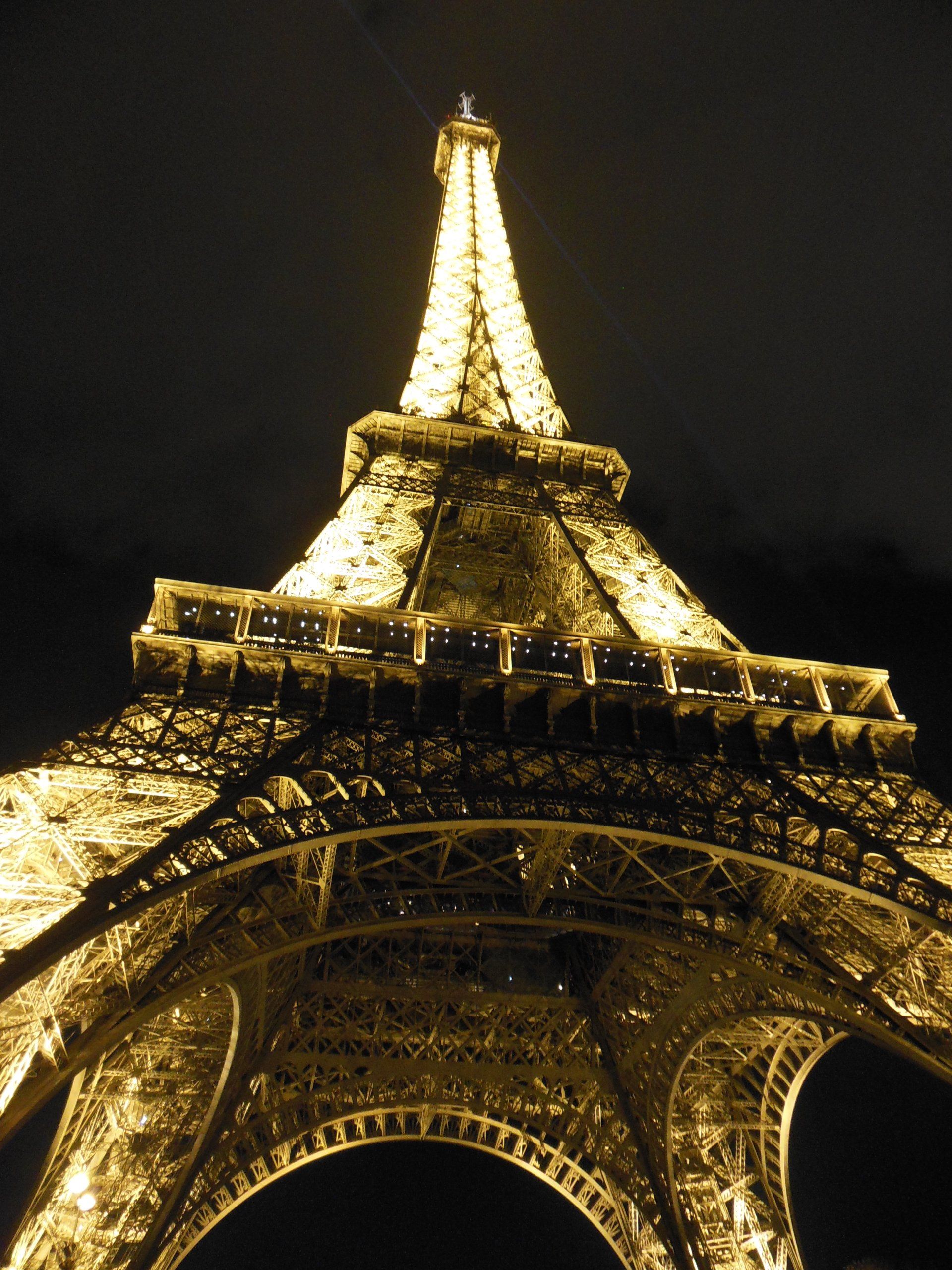 The eiffel tower is lit up at night in paris