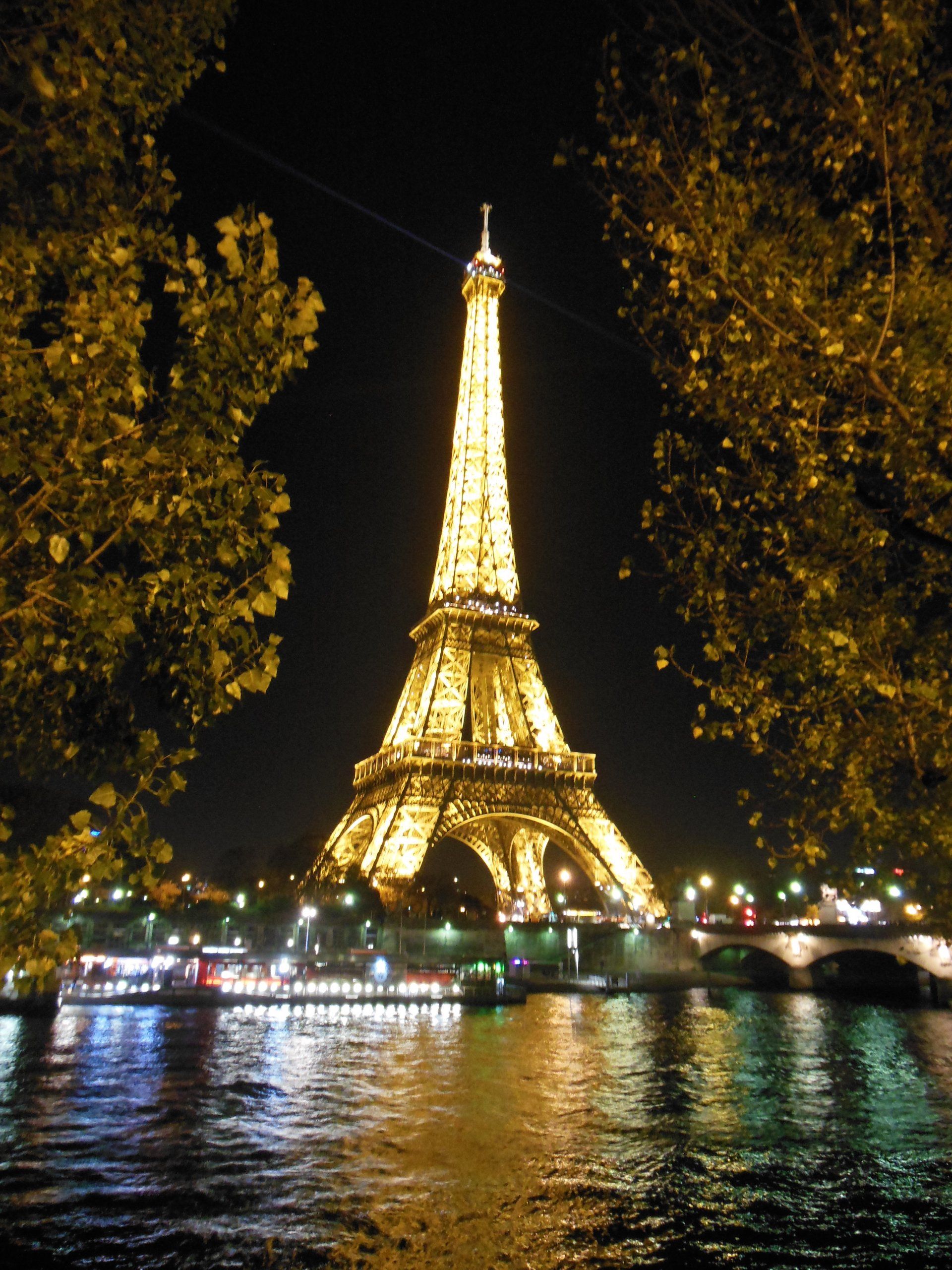 The eiffel tower is lit up at night in paris