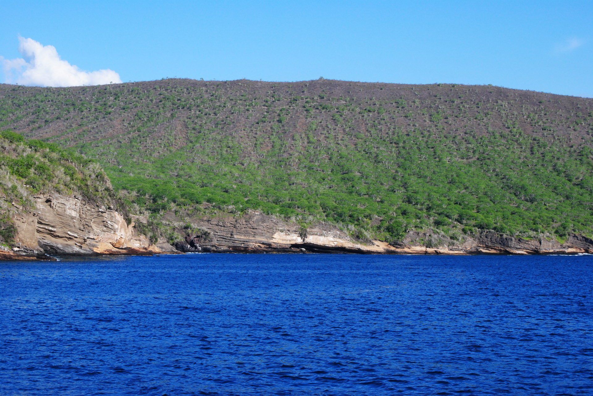 A large body of water with a mountain in the background