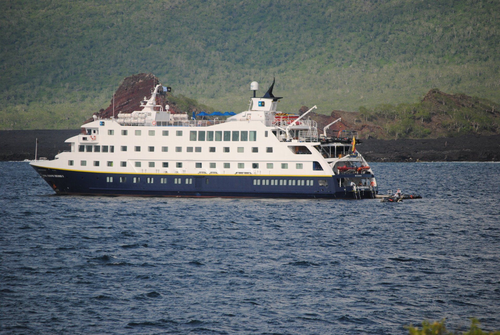 A large cruise ship is floating on top of a body of water.