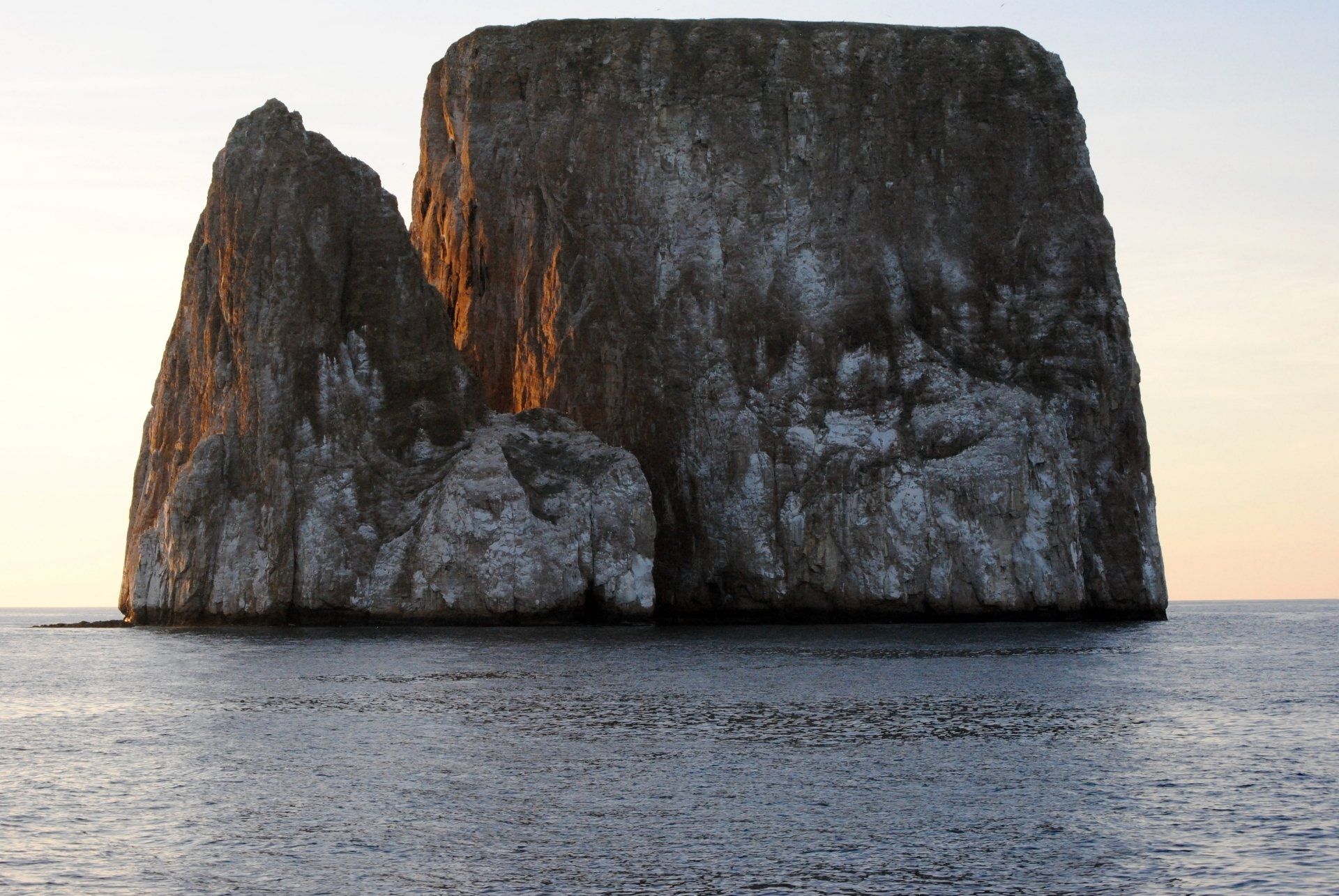 A large rock in the middle of the ocean