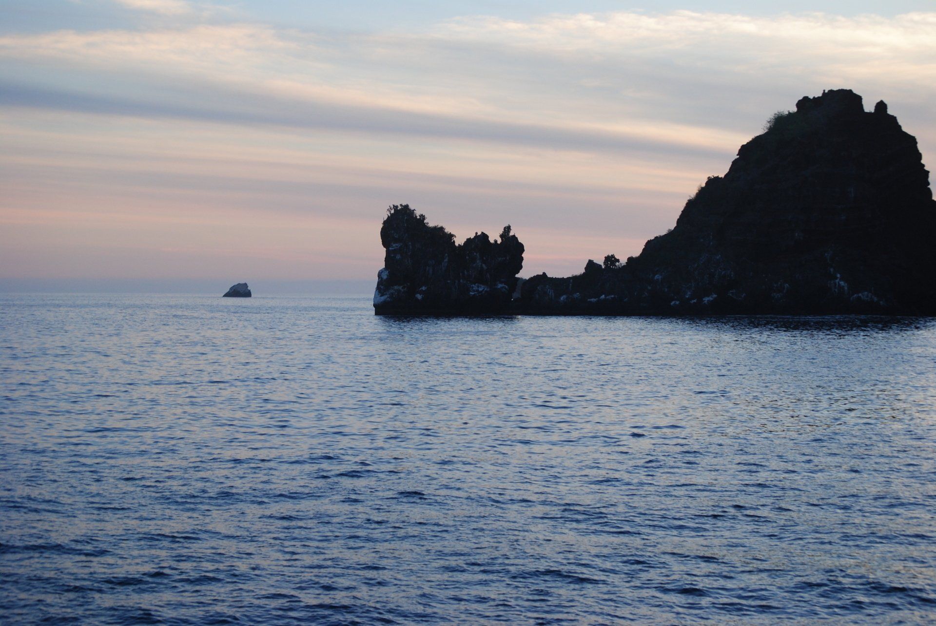 A large body of water with a small island in the distance