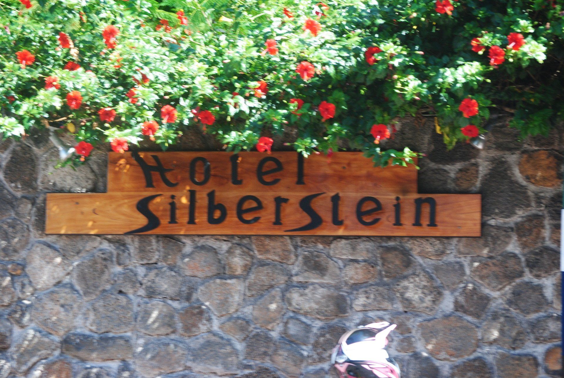 A sign on a stone wall says hotel silberstein