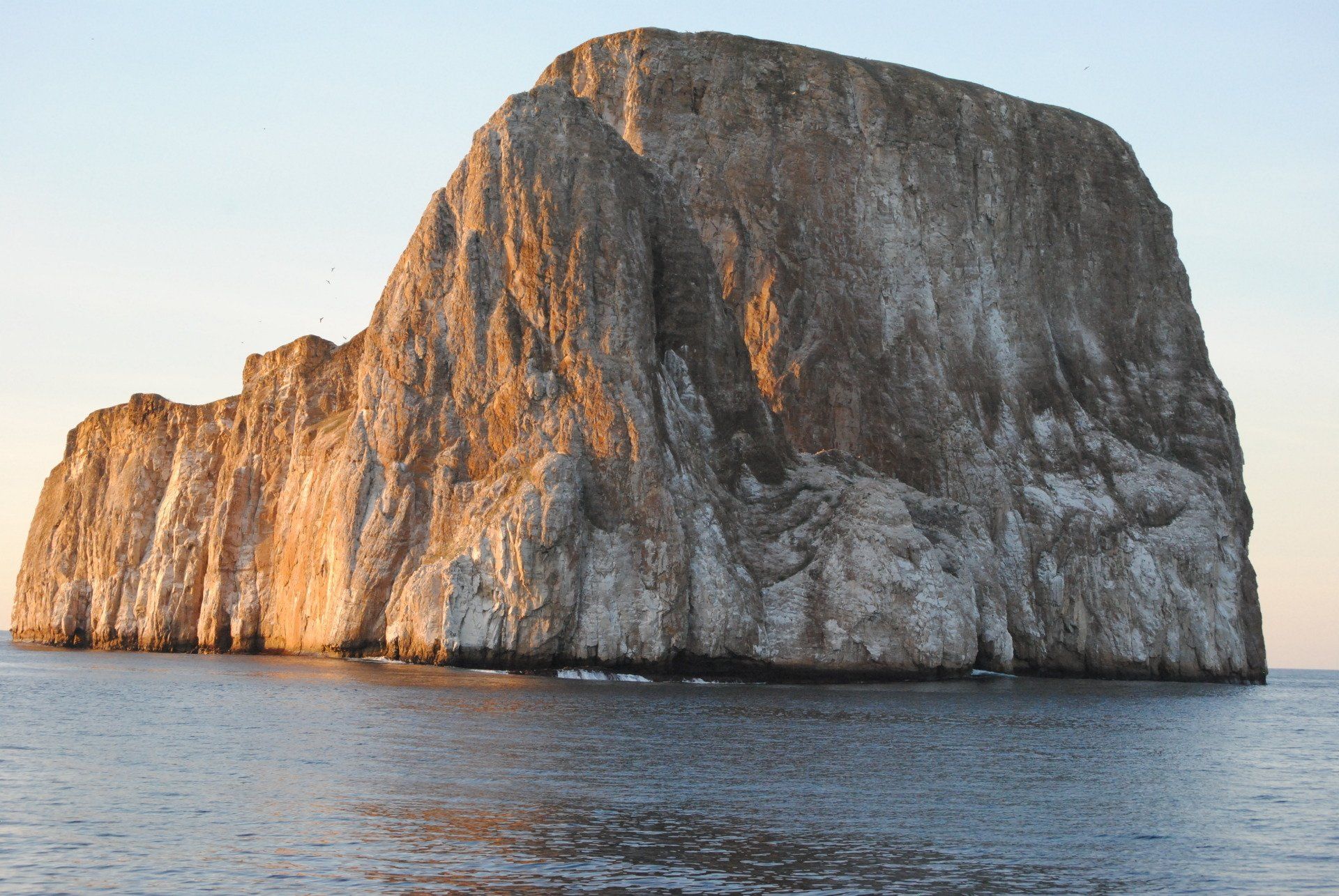 A large rock in the middle of the ocean
