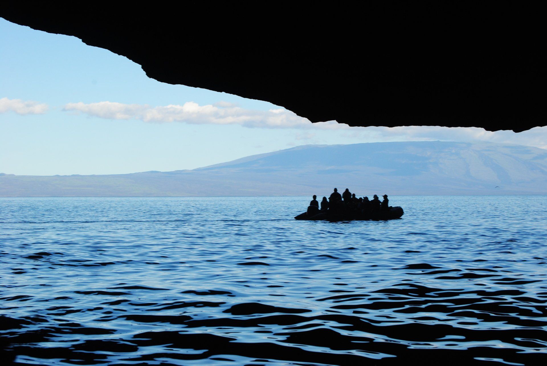 A group of people are in a boat in the ocean