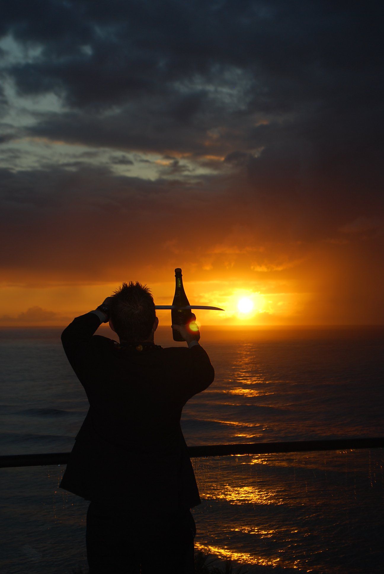 A man raising a bottle of wine