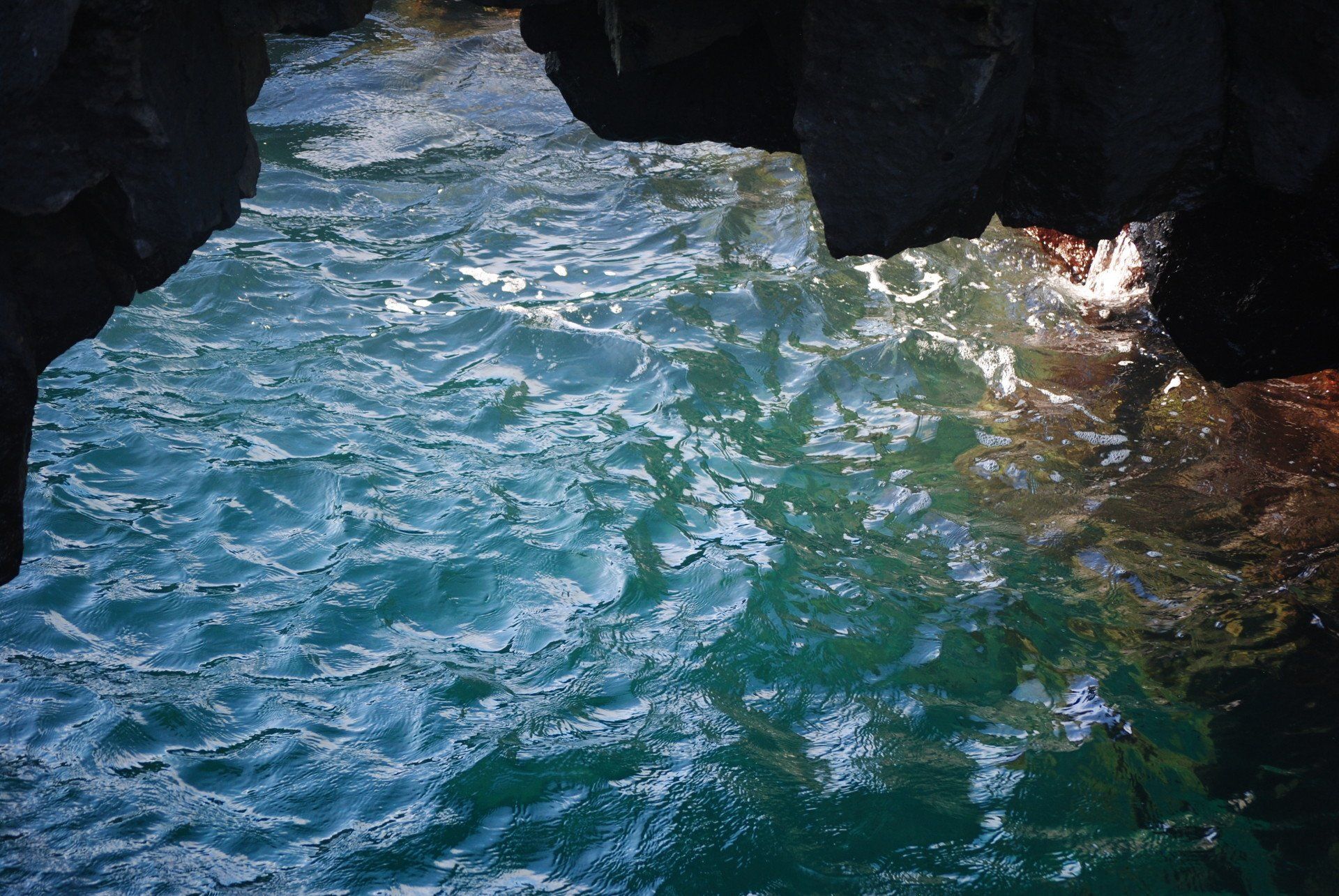 A close up of a body of water surrounded by rocks.