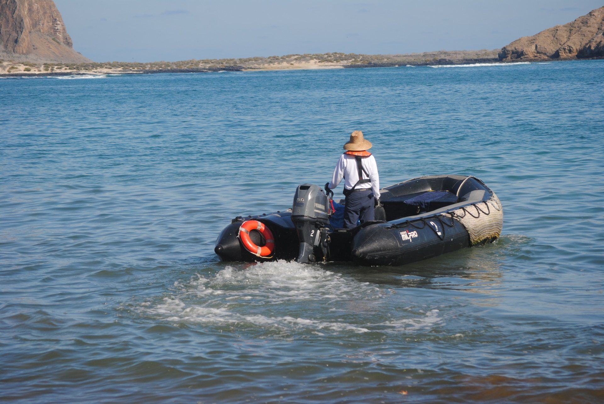 A man is in a boat in the ocean.