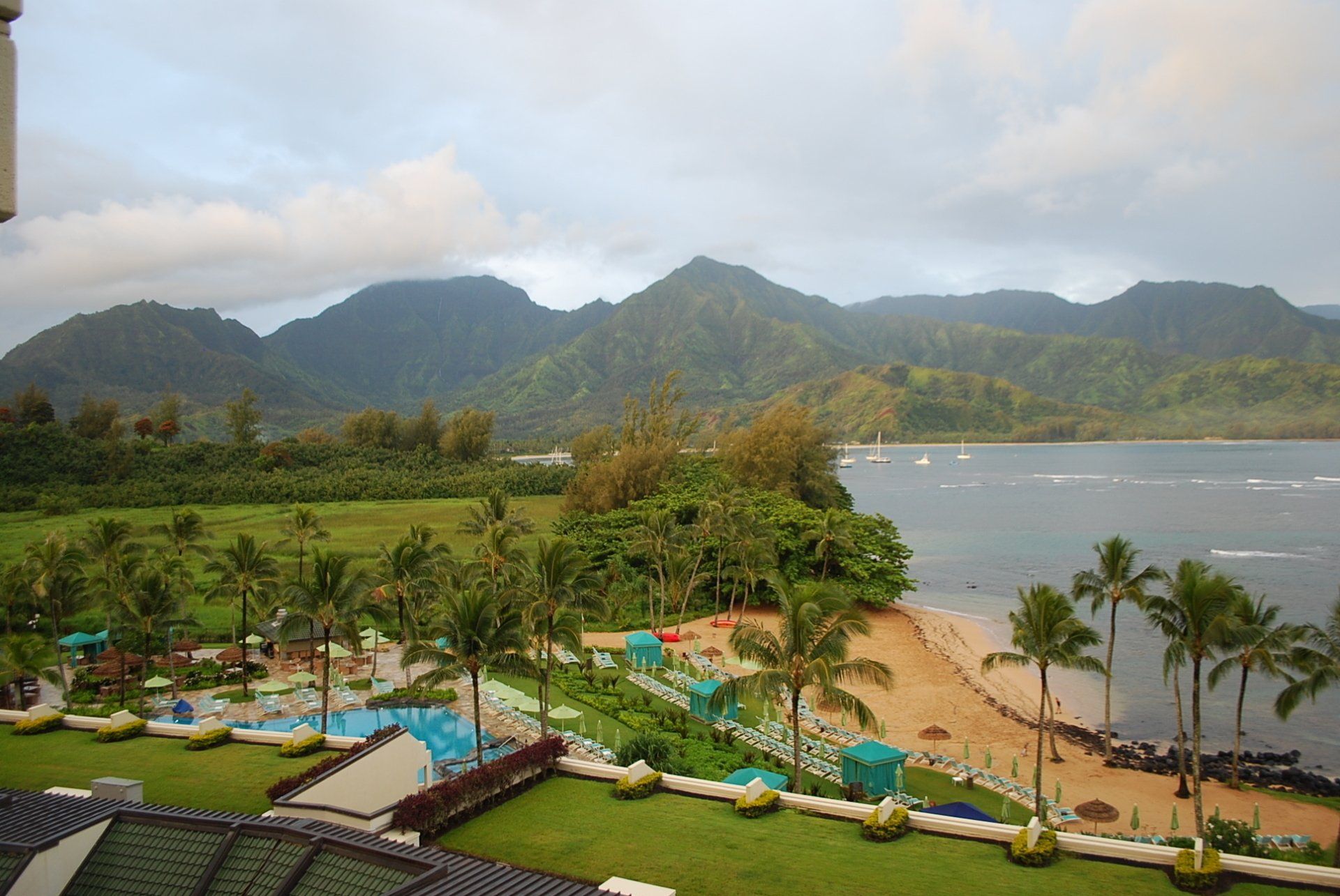 An aerial view of a beach resort with mountains in the background