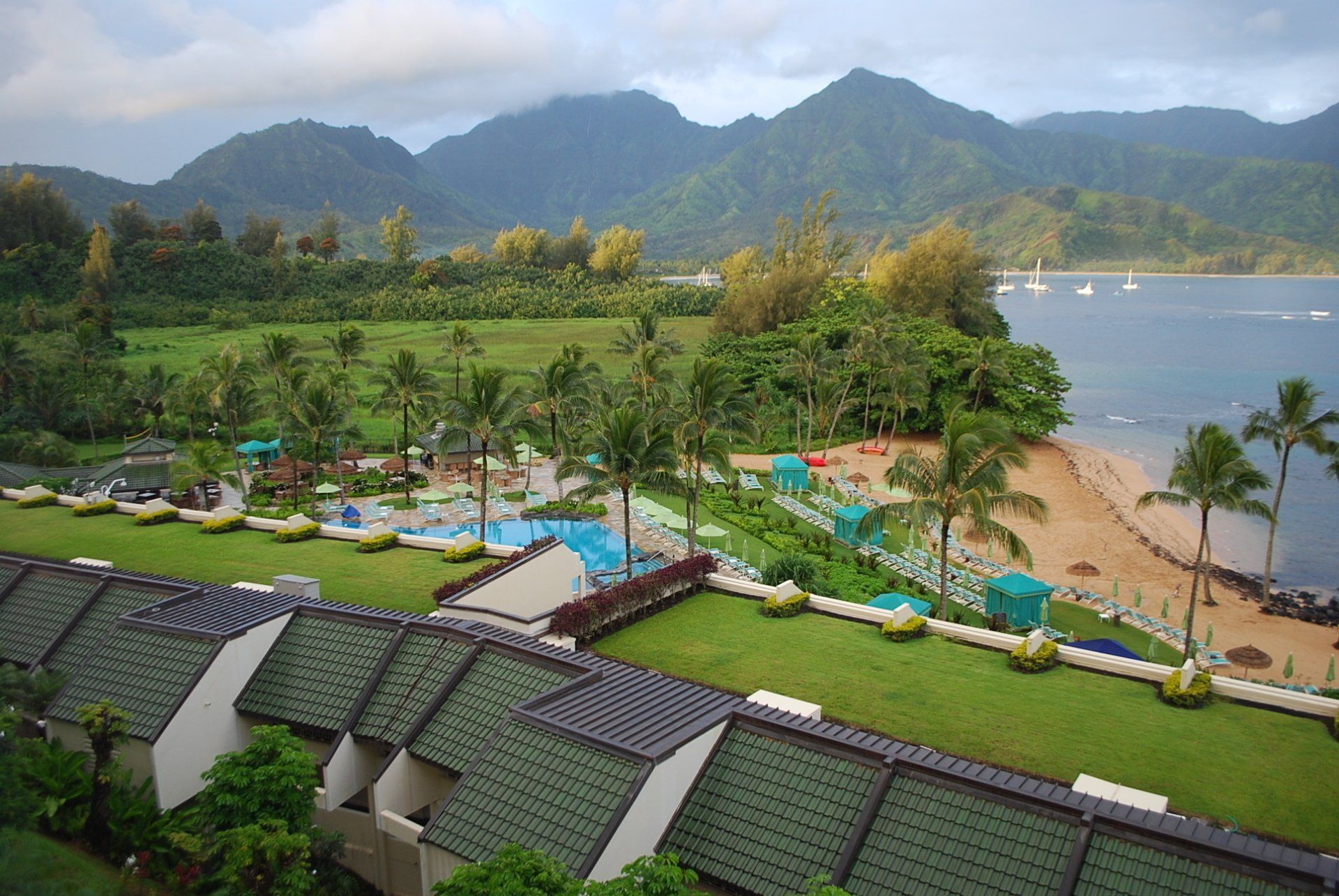 An aerial view of a resort with mountains in the background