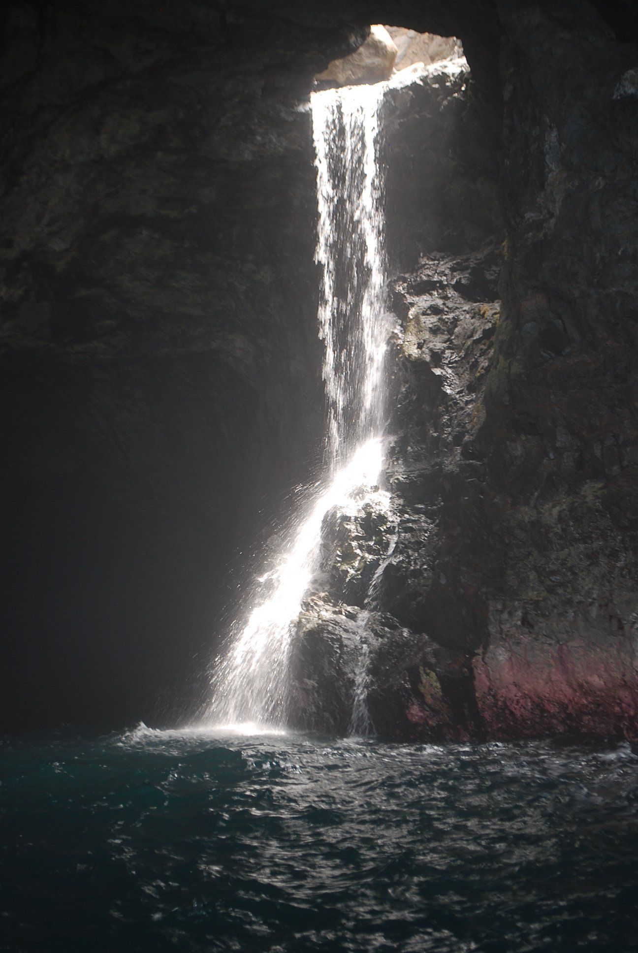 A waterfall in a cave in the middle of the ocean